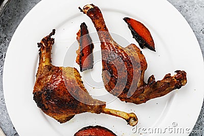 Baked duck with grilled oranges in a white plate close-up Stock Photo