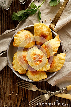 Baked dumplings stuffed with curd cheese and potatoes in a pan Stock Photo