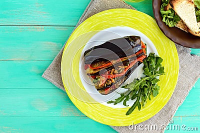 Baked eggplant slices stuffed with vegetables. Satisfying vegan dish. Stock Photo