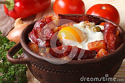 Baked eggs with chorizo and vegetables in the pot. Horizontal Stock Photo