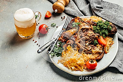 Baked Eisbein with sauerkraut and beer. Roasted knuckle of pork. German cuisine, Oktoberfest Stock Photo