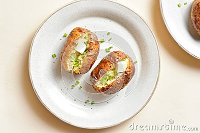 Baked filled potatoes with butter and green onion Stock Photo