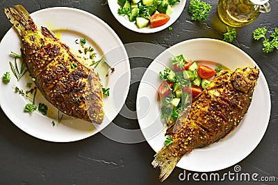 Baked fish on plate Stock Photo