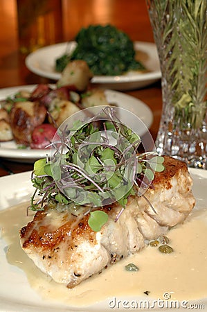 Baked fish and sides Stock Photo