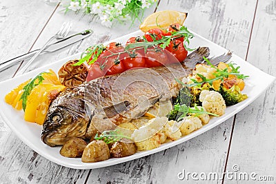 Baked fish with vegetables Stock Photo