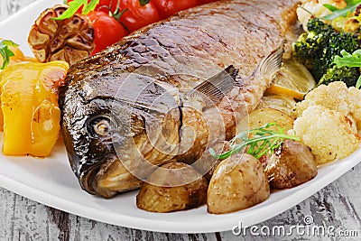 Baked fish with vegetables Stock Photo