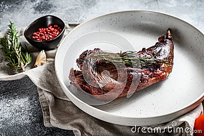 Baked hare leg with herbs, served on textile napkin. Organic meat. Top view Stock Photo