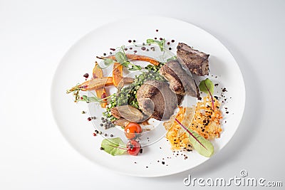 Baked meat with cheese, carrot, onion, green and tomatoes on white plate Stock Photo