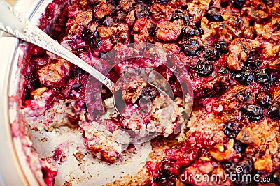 Baked oatmeal with berries and nuts, spoon in it, close-up Stock Photo