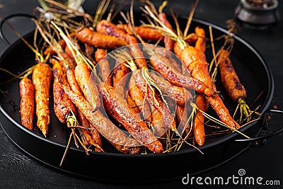 Baked organic carrots with thyme, honey and lemon. Stock Photo