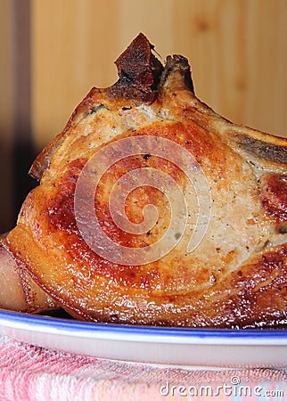Baked piece of pork meat on aluminum foil, the process of cooking meat dishes in the oven. Stock Photo