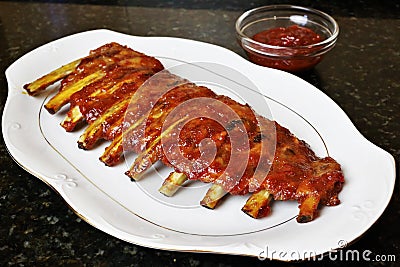 Baked pork ribs with barbecue or BBQ sauce.