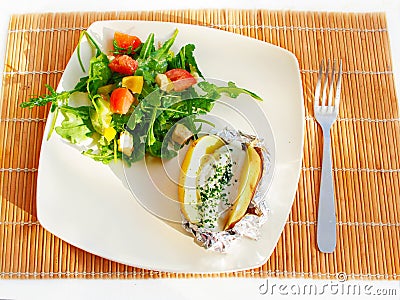 Baked foil potato with mixed salad and sauce Stock Photo