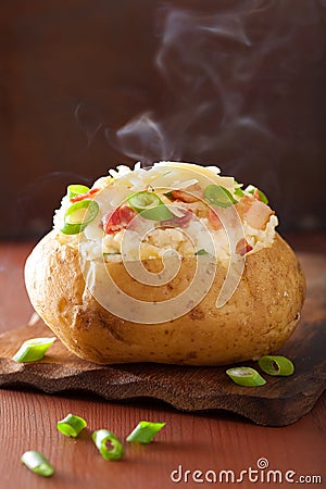 Baked potato in jacket with bacon and cheese Stock Photo