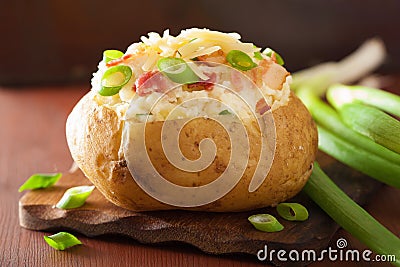 Baked potato in jacket with bacon and cheese Stock Photo