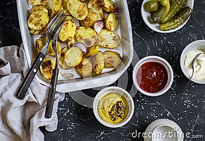 Baked potatoes and sauce him - homemade mayonnaise, ketchup and mustard. Delicious lunch or snack Stock Photo