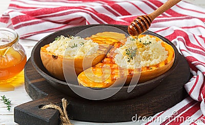 Baked pumpkin stuffed with couscous with honey and thyme Stock Photo