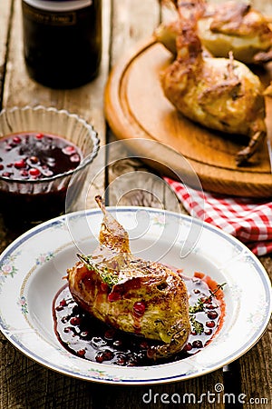 The baked quails with cowberry sauce Stock Photo