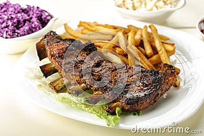 Baked ribs and French fries and cabbage salad Stock Photo