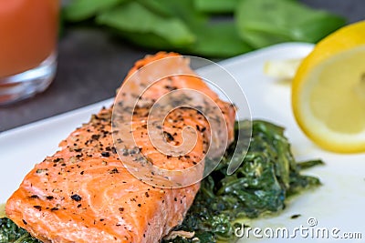 Baked salmo trutta on spinach. Stock Photo