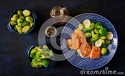 Baked salmon fish garnished with broccoli and Brussels sprouts with leek. Stock Photo