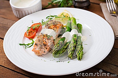 Baked salmon garnished with asparagus Stock Photo