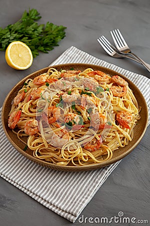 Baked Shrimp Scampi Linguine Pasta with Parsley on a Plate, side view Stock Photo