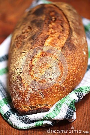 Baked sourdough loaf baked in clay oven, crust and crumb Stock Photo