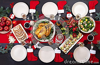 Baked turkey. Christmas dinner. The Christmas table is served with a turkey, decorated with bright tinsel and candles. Fried Stock Photo