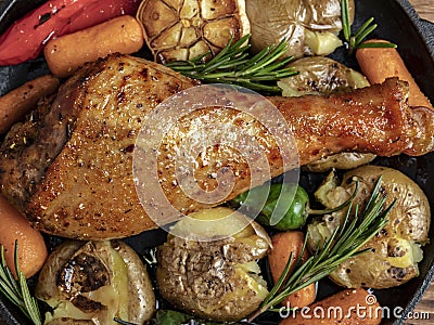 Baked turkey leg with vegetables, carrots, peppers, potatoes vegetables. close-up Stock Photo