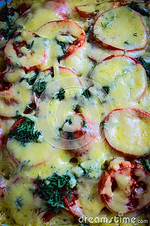 Baked vegetables with meat and potatoes, sprinkled with cheese Stock Photo
