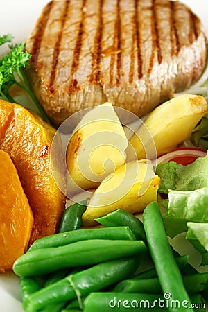 Baked Vegetables And Steak Stock Photo