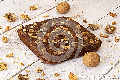 Baked walnut and oats chocolate cake on a light background Stock Photo