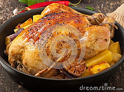 Baked whole chicken with potatoes Stock Photo