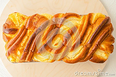 Baked yeast swirl cake, traditional French Brioche, staffed with cream cheese close up on wooden serving board Stock Photo