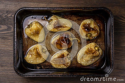 Baked yellow peppers in the baking pan, close up, top view. Vegetarian food Stock Photo