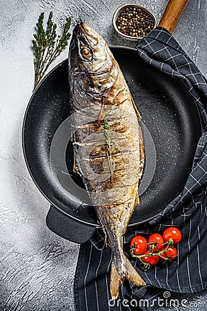 Baked Yellowtail, Japanese amberjack in a pan. Gray background. Top view Stock Photo