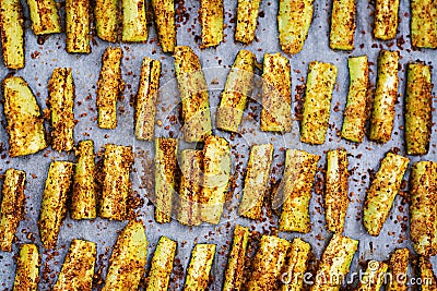 Baked zucchini sticks with cheese and bread crumbs. Vegan food. Stock Photo