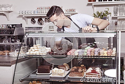 Baker and confectioner in pastry shop Stock Photo