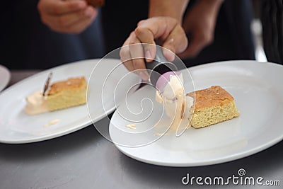 Baker decorating the delicious pastry cake Stock Photo