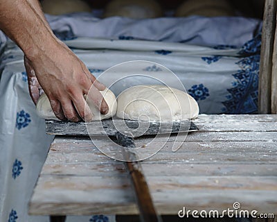 The baker prepares the dough for baking bread Stock Photo