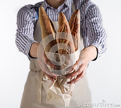 Baker`s hands hold fresh bread Stock Photo