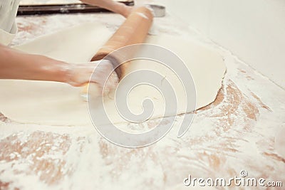 Baker`s hands rolling bread in kitchen Stock Photo