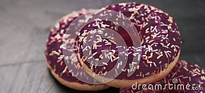 Frosted sprinkled donuts, sweet pastry dessert on rustic wooden background, doughnuts as tasty snack, top view food brand flat lay Stock Photo