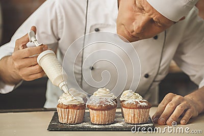 Bakery chef cooking bake in the kitchen professional Stock Photo