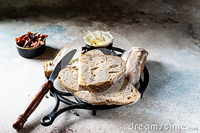 Bakery, crusty loaves of bread. Still life captured from above top view, flat lay . sun-dried tomatoes. Vegetarian food Stock Photo