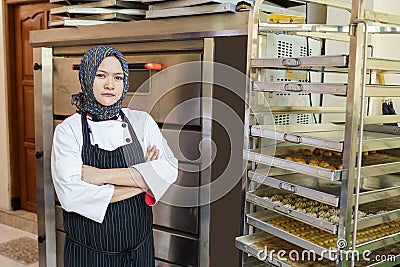 Bakery shop owner female muslim chef Stock Photo