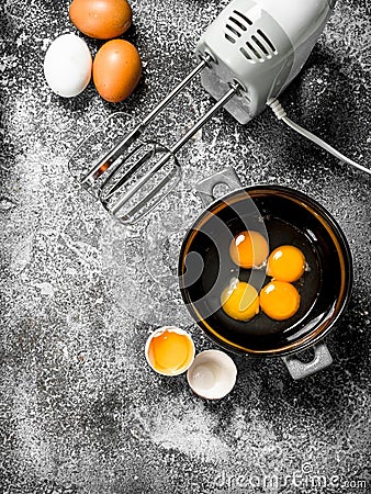 Baking background. Blend eggs with a mixer to make a dough. Stock Photo