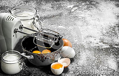 Baking background. Blend eggs with a mixer to make a dough. Stock Photo