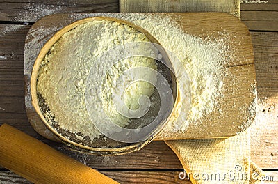 Baking background. Cooking ingredients for dough and pastry making and sprinkled with flour board on rustic wood. Top view with co Stock Photo